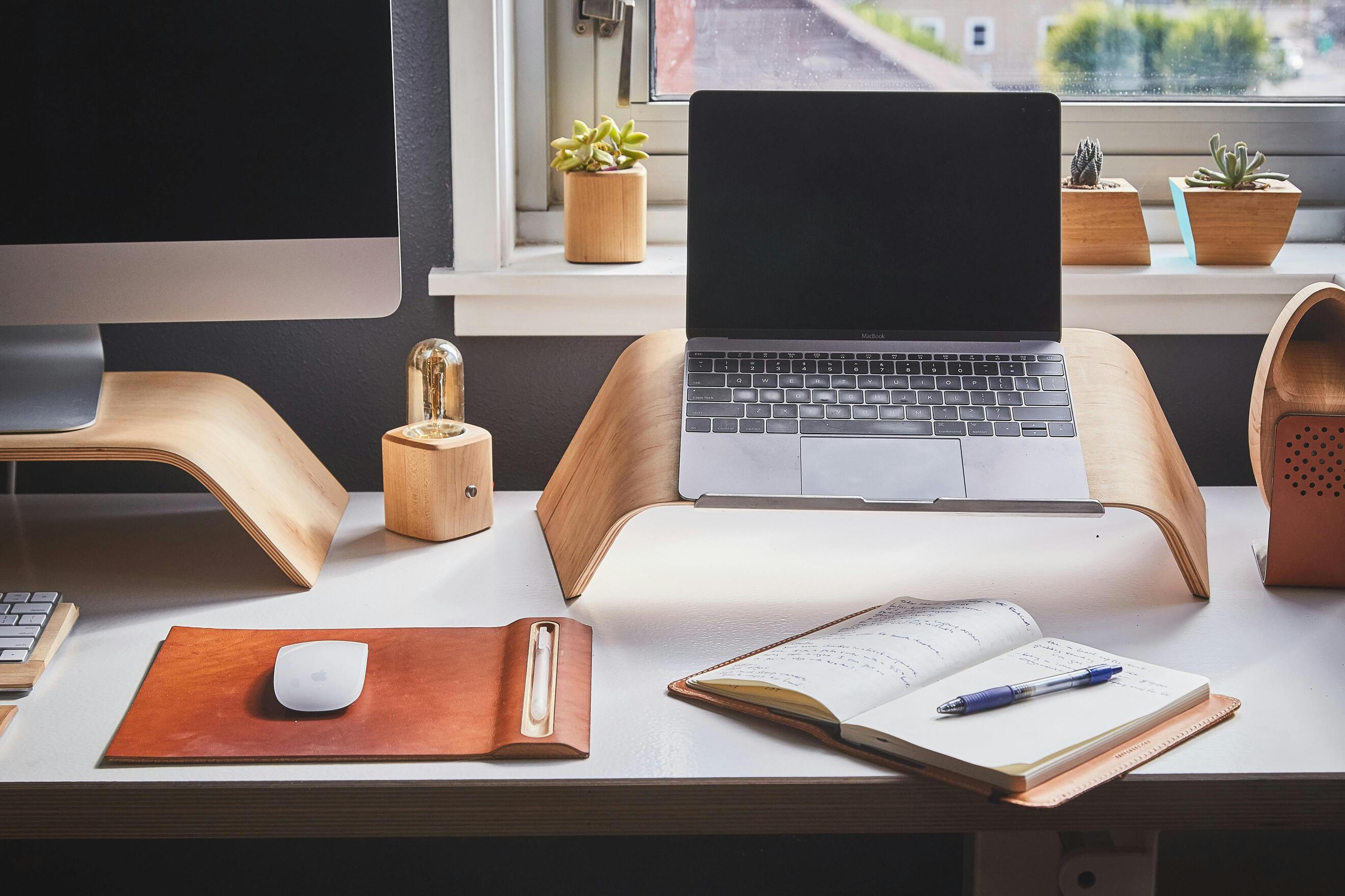 A photo of a laptop, turned off, on a desk.